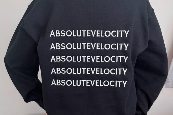 A black crewneck embroidered with a company name repeated five times across the back.