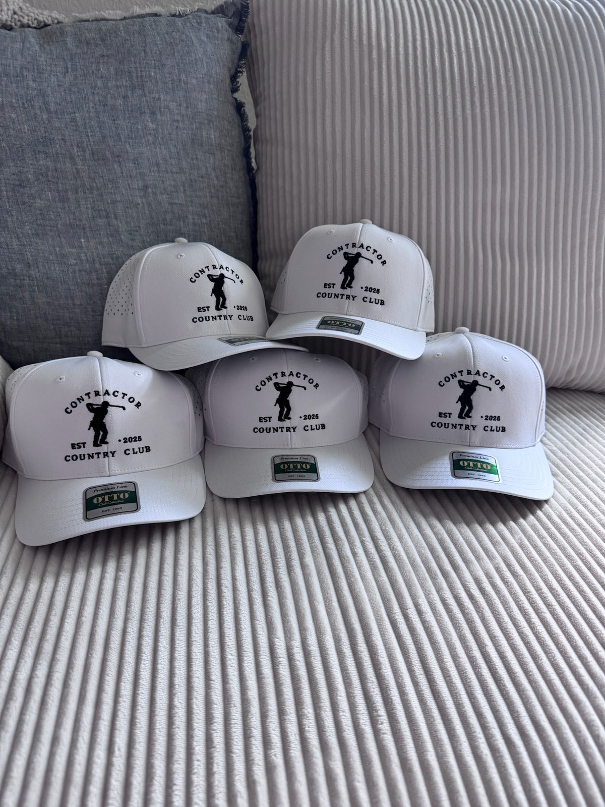 Contractor Country Club trucker hats stacked after a team run, embroidered by Threaded by Sal