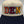 Close view of the DEN lettering, each letter a different color with a navy outline, embroidered by Threaded by Sal