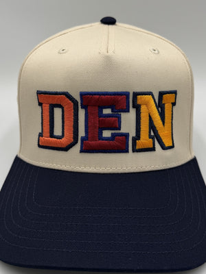 Close view of the DEN lettering, each letter a different color with a navy outline, embroidered by Threaded by Sal