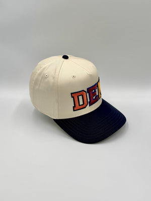 DEN 5-panel snapback in profile, showing the plain side panel and flat navy brim, embroidered by Threaded by Sal